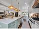 This kitchen boasts an open floor plan with stone countertops and stainless steel appliances at 14105 Ryker Way, Davidson, NC 28036