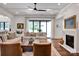 Bright living room with hardwood floors, a fireplace, large windows, and comfortable seating at 14105 Ryker Way, Davidson, NC 28036