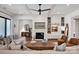 Bright living room featuring coffered ceiling, hardwood floors, a fireplace, and built-in shelving at 14105 Ryker Way, Davidson, NC 28036