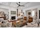 Cozy living room with a fireplace, built-in shelves, hardwood floors, and comfortable seating at 14105 Ryker Way, Davidson, NC 28036