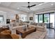 Open-concept living room connected to the kitchen, featuring comfortable seating and large windows at 14105 Ryker Way, Davidson, NC 28036