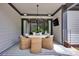Charming patio with a round dining table, stylish chandelier, and comfortable wicker chairs at 14105 Ryker Way, Davidson, NC 28036