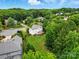Aerial view of a home featuring a large backyard enclosed by a wood fence and surrounded by lush greenery at 14616 Pomerol Ln, Pineville, NC 28134