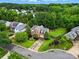 Stunning aerial view of a brick home showcasing well-manicured landscaping and a spacious, fenced backyard at 14616 Pomerol Ln, Pineville, NC 28134