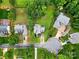 Aerial view showcasing the property's layout, including the lawn, trees, and neighborhood at 14616 Pomerol Ln, Pineville, NC 28134