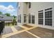 Spacious back deck with a detailed and modern design featuring direct home access and multiple windows at 14616 Pomerol Ln, Pineville, NC 28134