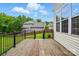 Back deck overlooking a fenced in backyard and lush green landscaping and a clear blue sky at 14616 Pomerol Ln, Pineville, NC 28134