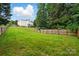 Large backyard with a full wood fence for privacy, lush green grass, and ample space for outdoor enjoyment at 14616 Pomerol Ln, Pineville, NC 28134