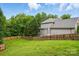 A sprawling green backyard surrounded by a tall wooden privacy fence and mature trees at 14616 Pomerol Ln, Pineville, NC 28134