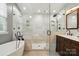 Bathroom features a frameless shower, free standing tub and dark wood cabinets at 14616 Pomerol Ln, Pineville, NC 28134
