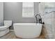 A serene bathroom with free standing tub and stylish fixtures at 14616 Pomerol Ln, Pineville, NC 28134