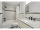 A beautifully designed bathroom with a shower-tub combination and modern fixtures at 14616 Pomerol Ln, Pineville, NC 28134