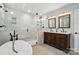 Renovated bathroom with luxurious soaking tub, and walk-in shower at 14616 Pomerol Ln, Pineville, NC 28134