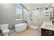 Bright, renovated bathroom with a free-standing tub, large shower and custom vanity at 14616 Pomerol Ln, Pineville, NC 28134