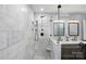 Elegant bathroom featuring marble tile, glass shower and double vanity at 14616 Pomerol Ln, Pineville, NC 28134