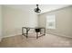 Well-lit room featuring carpeted floors and a contemporary black desk in front of a window at 14616 Pomerol Ln, Pineville, NC 28134
