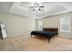 Bright bedroom features a tray ceiling, ceiling fan and plush carpeting at 14616 Pomerol Ln, Pineville, NC 28134