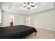Spacious bedroom shows access to the bathroom and neutral carpeting at 14616 Pomerol Ln, Pineville, NC 28134