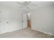 Room with carpet, overhead fan and view down hall at 14616 Pomerol Ln, Pineville, NC 28134