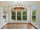 Open dining area featuring dark hardwood flooring and a modern lighting fixture, great for entertaining at 14616 Pomerol Ln, Pineville, NC 28134