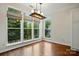 Open dining area with hardwood floors, natural lighting and multiple windows with peaceful wooded view at 14616 Pomerol Ln, Pineville, NC 28134