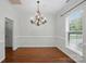 Formal dining room featuring hardwood flooring, chandelier, and wainscoting at 14616 Pomerol Ln, Pineville, NC 28134