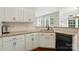 Functional kitchen area with granite countertops, white cabinetry, and ample natural light at 14616 Pomerol Ln, Pineville, NC 28134
