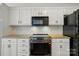 Bright kitchen featuring granite countertops, white cabinets, tile backsplash, and stainless steel oven and microwave at 14616 Pomerol Ln, Pineville, NC 28134