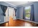 Bright living room featuring hardwood flooring, double doors and view to the outside at 14616 Pomerol Ln, Pineville, NC 28134