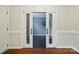Living room with hardwood flooring and double doors at 14616 Pomerol Ln, Pineville, NC 28134