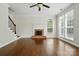 Bright living room with hardwood floors, fireplace, and staircase at 14616 Pomerol Ln, Pineville, NC 28134