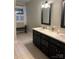 Bathroom highlighting a double sink vanity with dark cabinets, white countertops, and checkered floors at 1619 Bellamy Cir, Albemarle, NC 28001