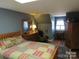 Cozy bedroom featuring a quilted bedspread and a traditional wooden dresser with a mirror at 1619 Bellamy Cir, Albemarle, NC 28001