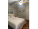 Neutral bedroom showcasing a comfy bed, ceiling fan, and simple decorations, creating a relaxing atmosphere at 1619 Bellamy Cir, Albemarle, NC 28001