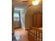 Bedroom displaying wooden floors, warm lighting, and an armoire, accented by a ceiling fan and a window at 1619 Bellamy Cir, Albemarle, NC 28001