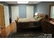 Bedroom with hardwood floors, a patterned quilt, and natural wood accents with lots of natural light at 1619 Bellamy Cir, Albemarle, NC 28001