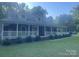 Inviting brick home boasting a wide, covered front porch and manicured landscaping at 1619 Bellamy Cir, Albemarle, NC 28001