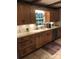 Updated kitchen features wooden cabinets, modern countertops, and a colorful accent rug at 1619 Bellamy Cir, Albemarle, NC 28001