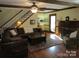 Comfortable living room with hardwood floors, exposed beams, and a traditional fireplace at 1619 Bellamy Cir, Albemarle, NC 28001