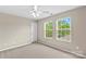 Well-lit bedroom with neutral walls and two windows at 18339 The Commons Blvd, Cornelius, NC 28031
