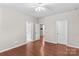 Bedroom with hardwood floors featuring multiple doors leading to other rooms at 18339 The Commons Blvd, Cornelius, NC 28031
