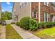 Charming exterior showcasing a well-maintained home with a combination of brick and siding, lush landscaping, and a welcoming walkway at 18339 The Commons Blvd, Cornelius, NC 28031