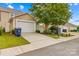 Attached two-car garage and landscaped driveway for easy parking at 18339 The Commons Blvd, Cornelius, NC 28031