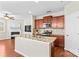 Stylish kitchen with granite countertops, stainless steel appliances, and a center island, seamlessly connecting to the living area at 18339 The Commons Blvd, Cornelius, NC 28031