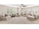 Bright living room with large windows, neutral color scheme, and comfortable seating arrangement at 18339 The Commons Blvd, Cornelius, NC 28031