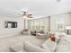 Bright living room features neutral walls, large windows, ceiling fan, and comfortable seating at 18339 The Commons Blvd, Cornelius, NC 28031