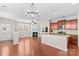 Spacious living room featuring an open layout, fireplace, and hardwood floors, seamlessly connecting to a modern kitchen area at 18339 The Commons Blvd, Cornelius, NC 28031