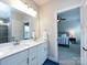 Bathroom featuring double vanity, modern fixtures, and a glass-enclosed shower, offering a luxurious experience at 1839 Shumard Ln, Charlotte, NC 28205