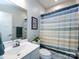 Bright bathroom featuring a shower with a colorful striped curtain and modern fixtures at 1839 Shumard Ln, Charlotte, NC 28205