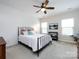 Cozy bedroom with ceiling fan, comfortable bed, and windows for natural light at 1839 Shumard Ln, Charlotte, NC 28205